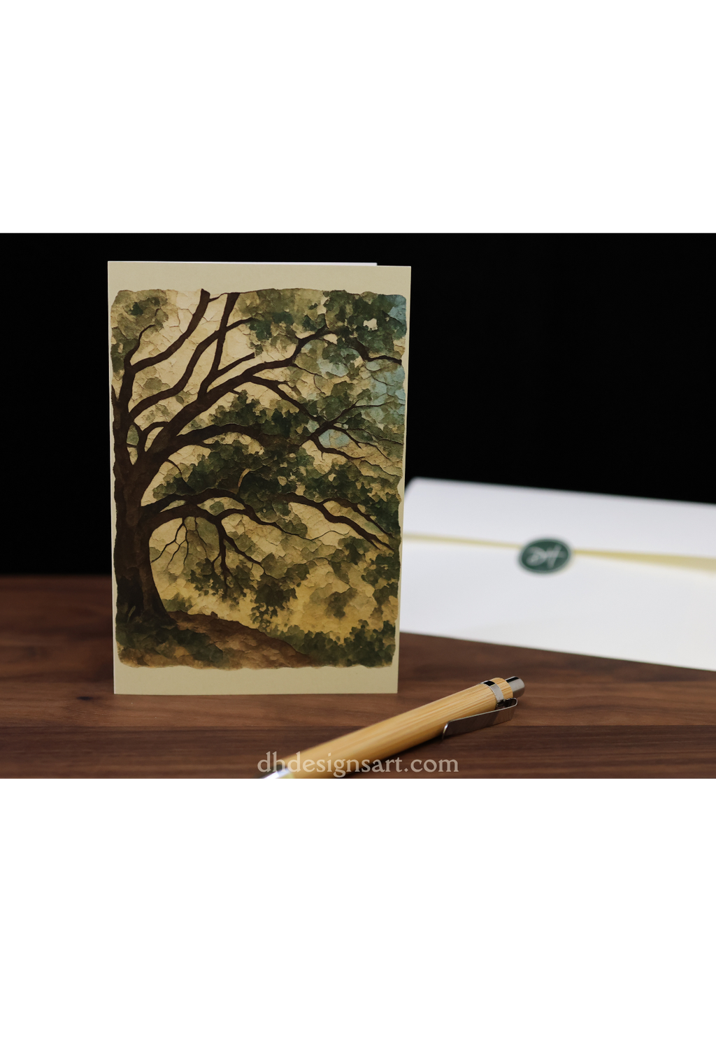 Greeting card with a tree design on a wooden surface with a pen.
