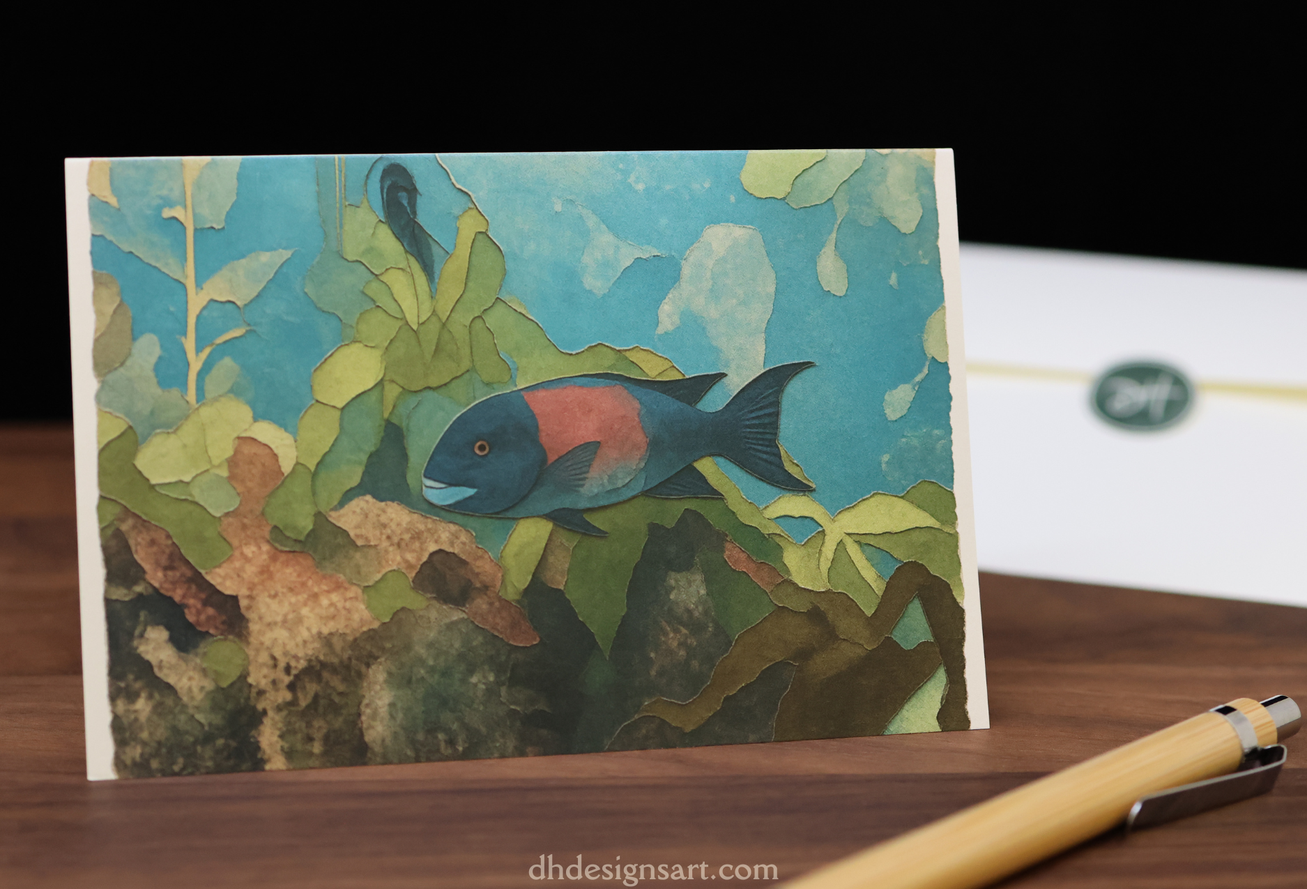 Blank notecard with a sheepshead fish illustration on a wooden desk with a pen and envelope. dhdesignsart.com.