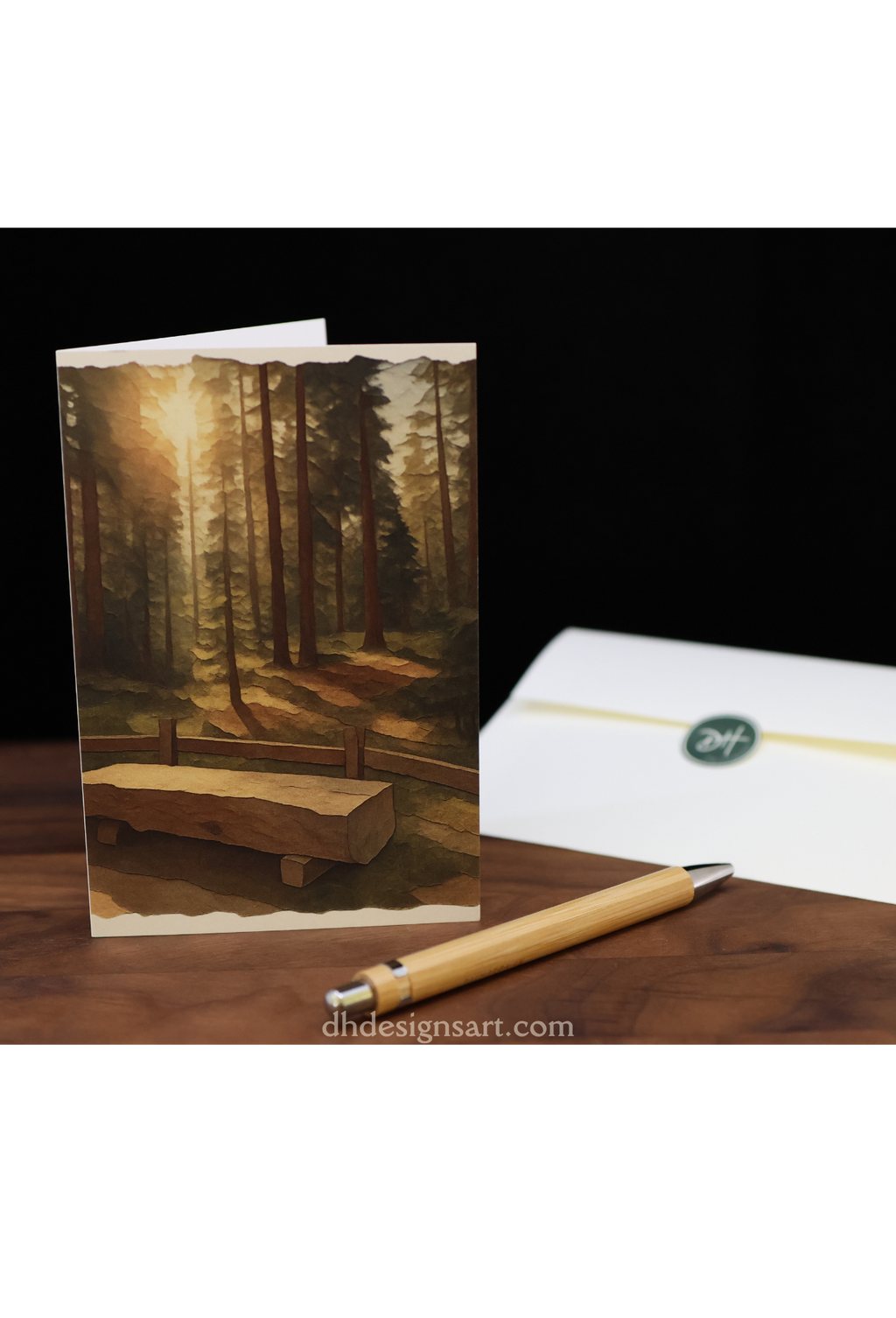 Blank notecard with Yosemite pine forest design on a wooden desk with a pen and envelope, dhdesignsart.com.